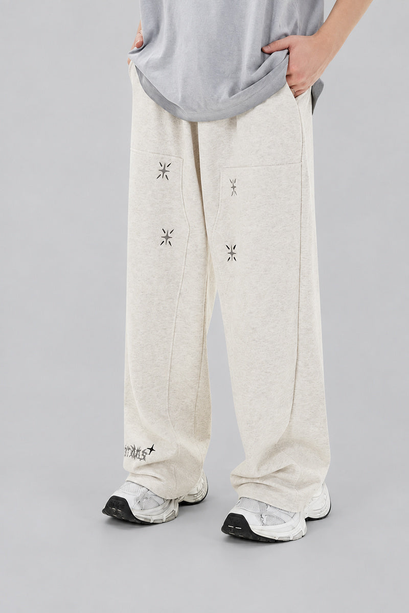Jogging Y2K édition 'Star Burst Beige', vue de face, sur fond studio gris clair.
